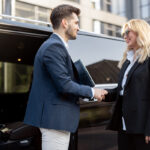 female-chauffeur-with-a-businessman-near-minivan-t-2025-03-13-15-32-27-utc
